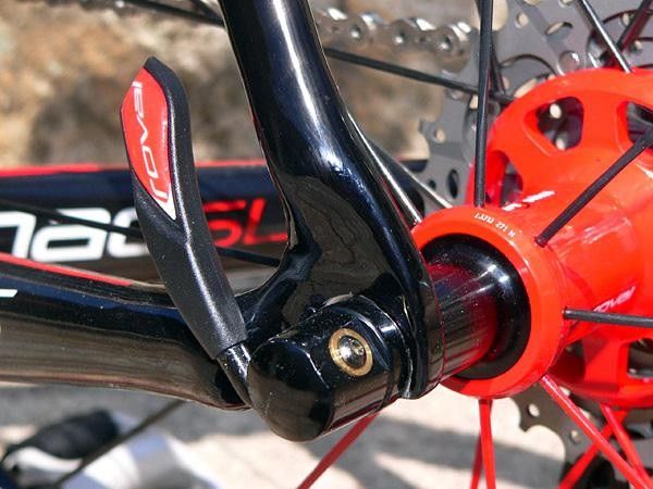 Carbon fiber dropouts are sandwiched with protective metal plates.