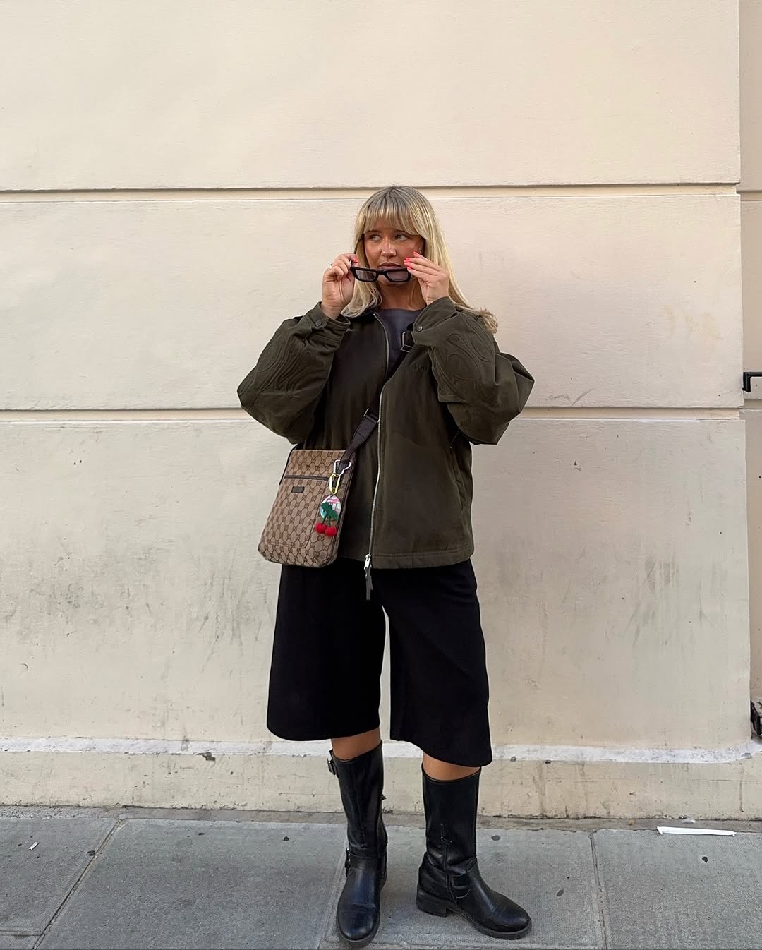 woman wearing bermuda shorts with boots outfit 2025