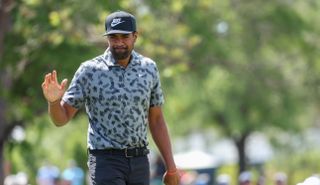 Tony Finau waves to the crowd after holing a putt