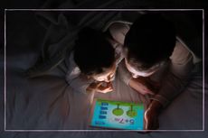 Kids using tablet in bed playing app game