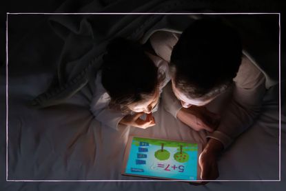 Kids using tablet in bed playing app game