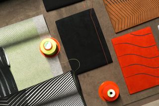 Fabric and thread options displayed inside Maserati showroom customisation atelier