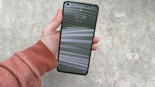 A Realme GT 2 Pro from the front, in someone's hand
