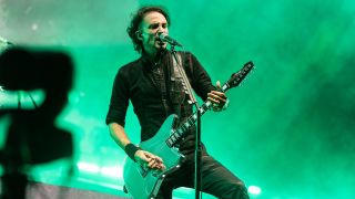 Joe Duplantier on stage screaming