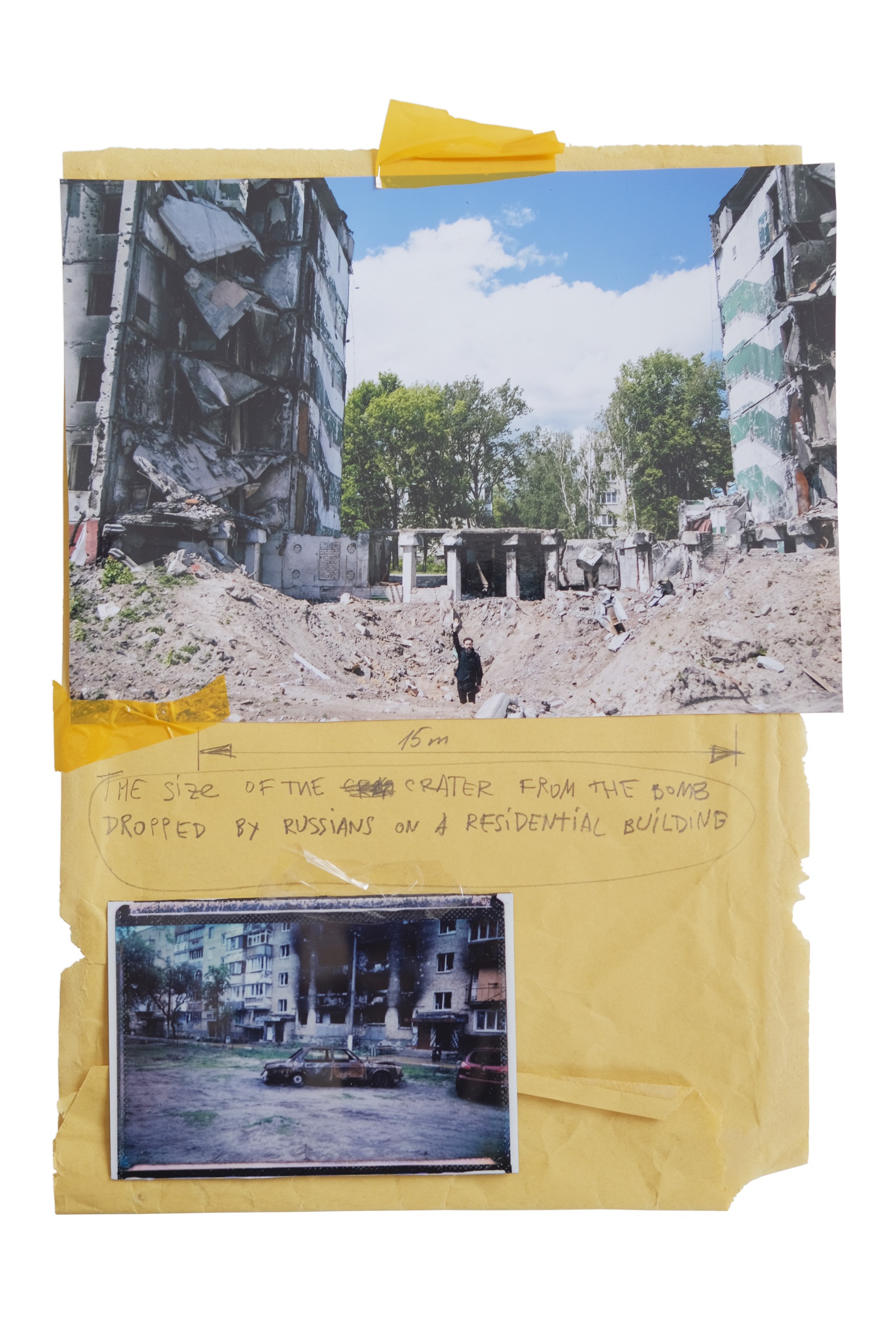 A collage on yellow paper of a bomb crater between ruined apartment blocks, with a handwritten note about its size