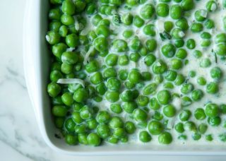 a casserole of braised peas in cream with mint
