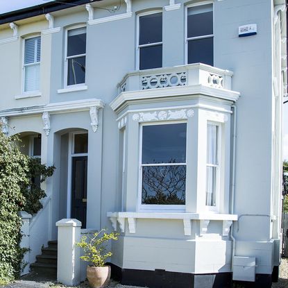 house with white wall and dark blue door 