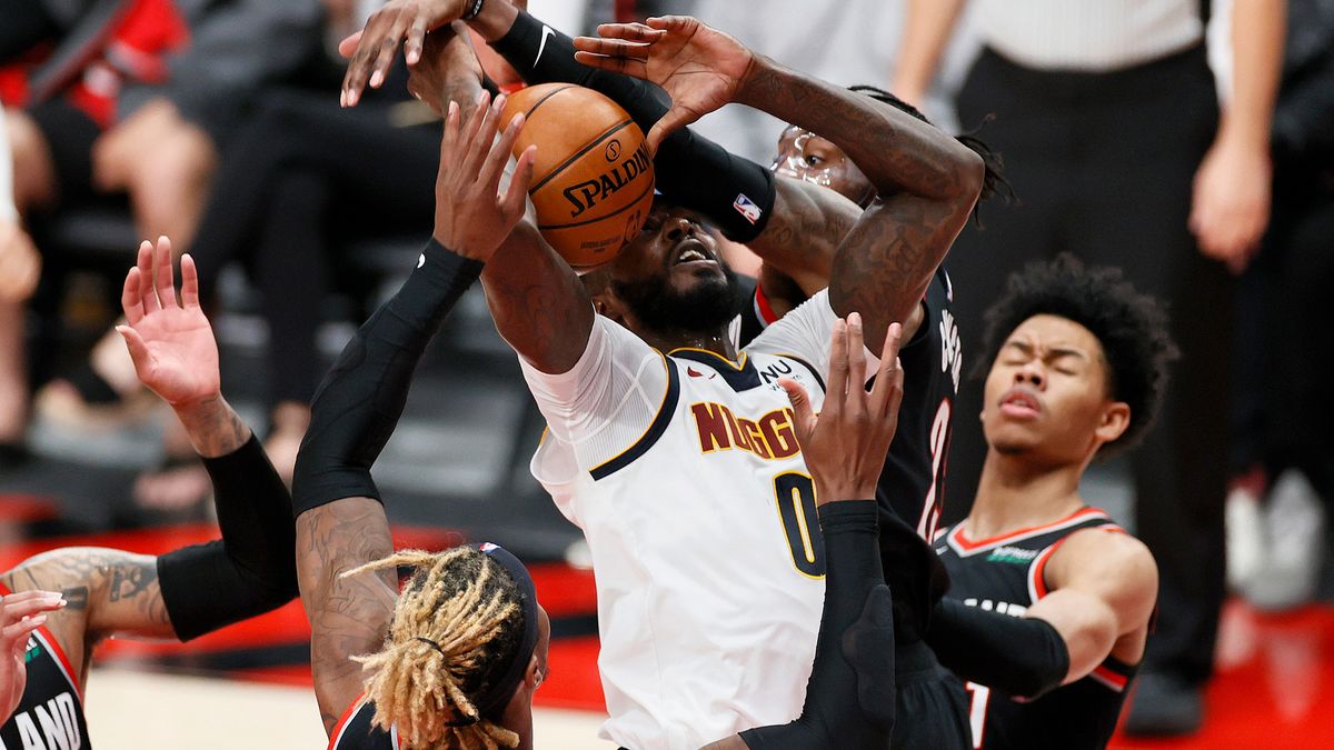 JaMychal Green #0 of the Denver Nuggets is fouled by Robert Covington #23 of the Portland Trail Blazers in the third quarter during Round 1, Game 4 of the 2021 NBA Playoffs at Moda Center on May 29, 2021 in Portland, Oregon.