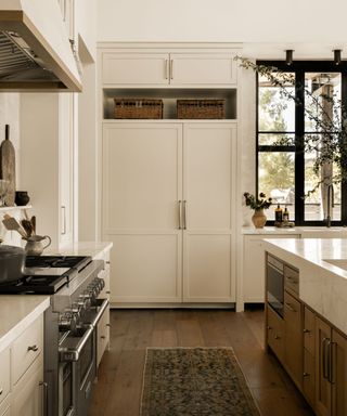 warm white kitchen with built-in cabinets, black window frames and modern rustic decor