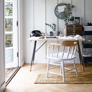 home office with table chair and panelled wall