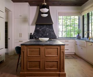 Modern farmhouse kitchen with a black decorative range hood