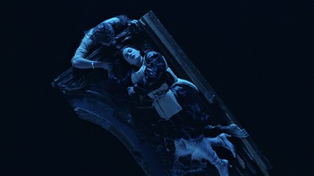 Bird's eye view of Rose laying on the on the door raft in Titanic, while Jack hangs off.