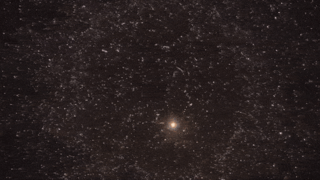 Looped video footage of an animation showing a star getting ripped apart by a black hole before a bright flash