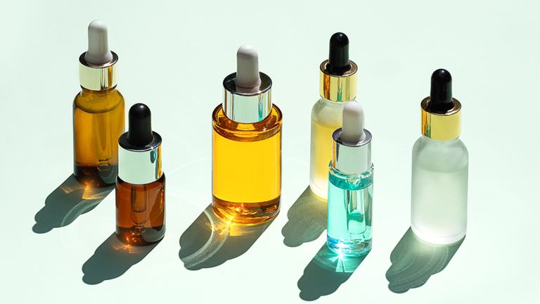 woman applying facial serum