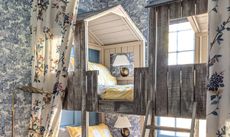 Blue bunk room makeover with feature woodland wallpaper 
