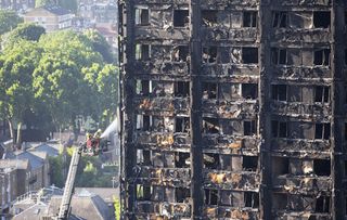 Water is sprayed on Grenfell Tower in west London after a fire engulfed the 24-storey building