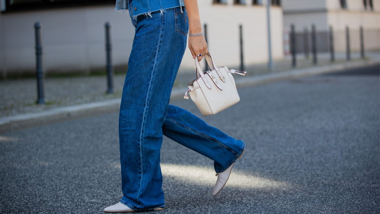 Woman in Levi&#039;s blue jeans and a blue denim jacket.