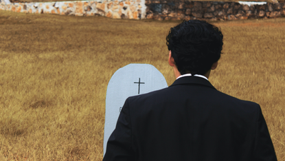 Man at gravestone