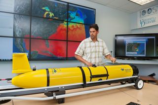 University of Delaware researcher Matthew Oliver with the underwater robot used to track sand tiger sharks on the East Coast of the U.S.