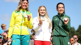 Silver Medalist, Zoe Cuthbert of Team Australia, Gold Medalist, Evie Richards of Team England and Bronze Medalist, Candice Lill of Team South Africa stand with their medals on the podium during the Women's Cross-country medal ceremony on day six of the Birmingham 2022 Commonwealth Games at Cannock Chase