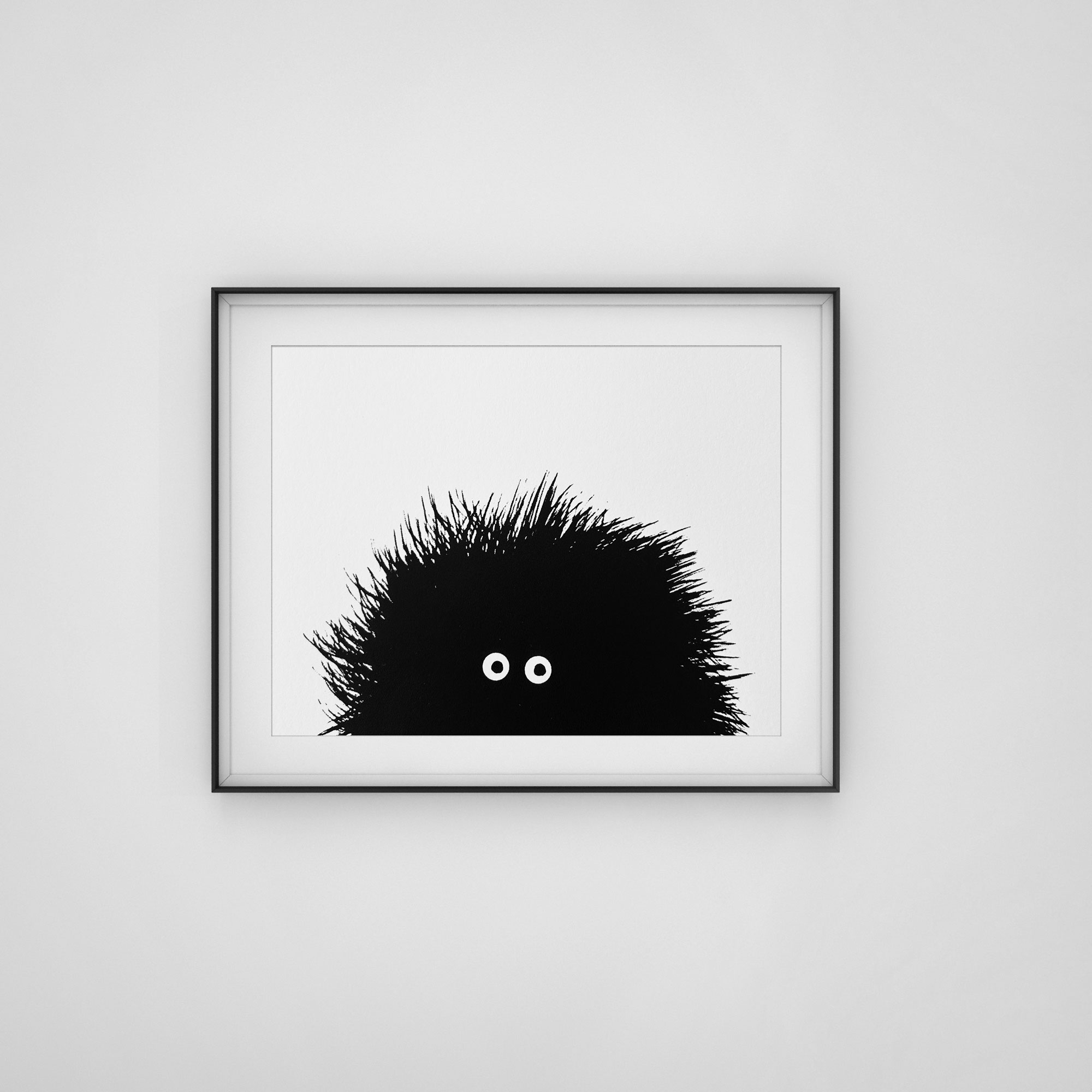 Black framed screenprint of black hairy creature with big eyes