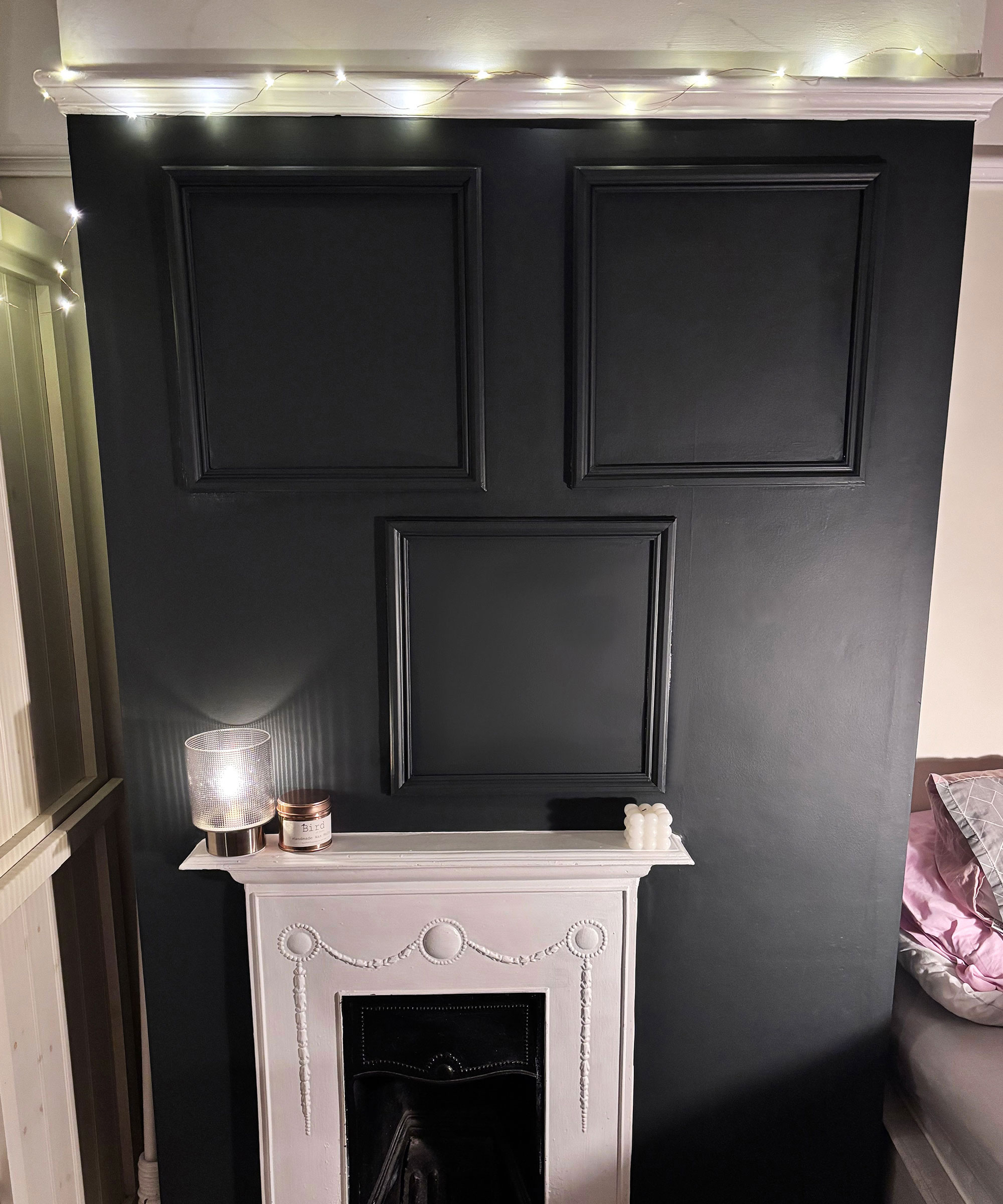 black chimney breast with wall panelling and white fireplace
