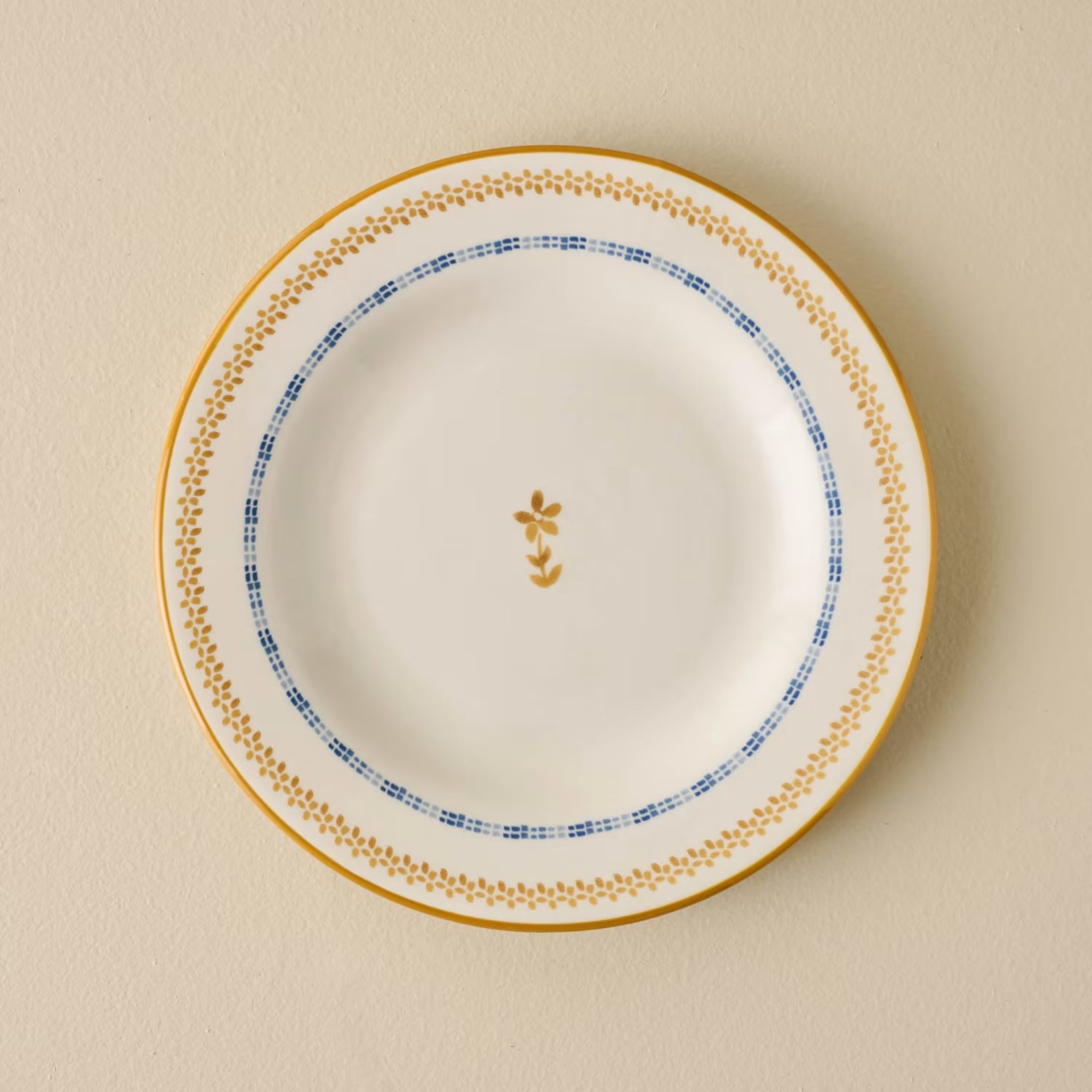 Cream plate with yellow edging and yellow flower in the middle