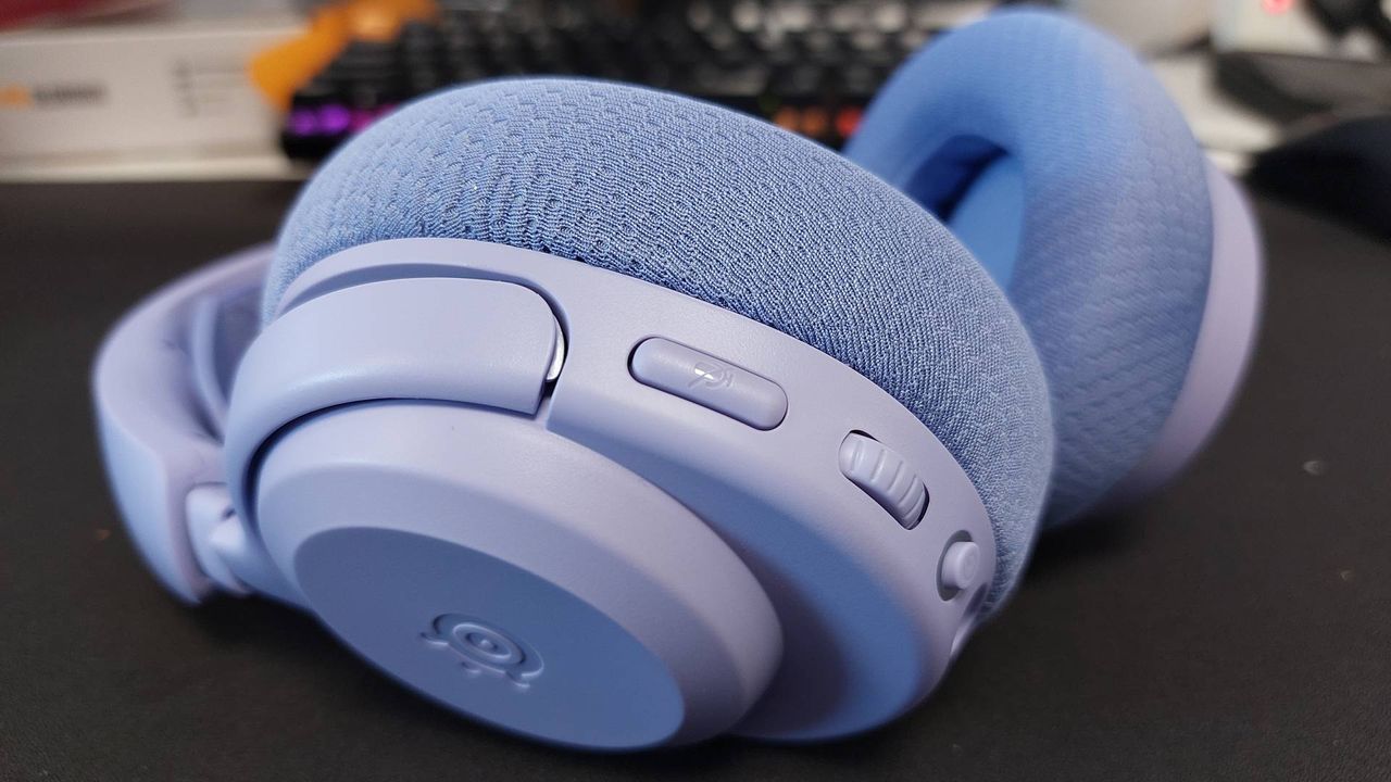 The SteelSeries Arctis Nova 3 X seen on a desk. This is the Lavender colourway.