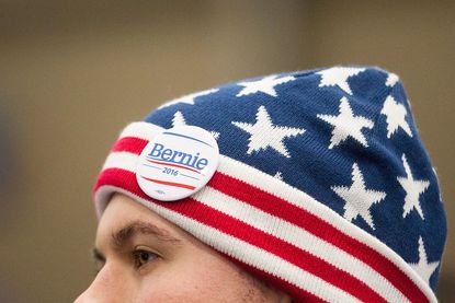 A Bernie Sanders supporter in Michigan wears a Sanders button on his patriotic beanie