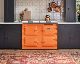 orange aga in a Neptune kitchen with a rug