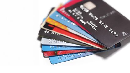 A pile of credit cards against a white backdrop.