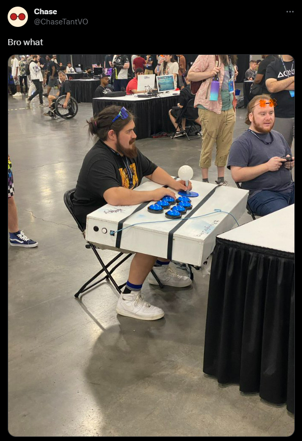 An EVO 2023 attendee with a massively oversized fightstick.