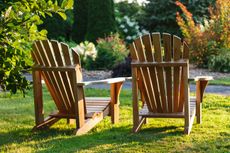 wooden adironrack chairs on a lawn