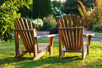 wooden adironrack chairs on a lawn
