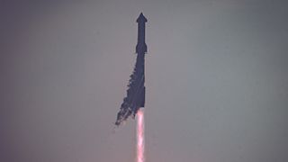 a big rocket launches into a cloudy gray sky.