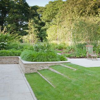 sloping garden with grass steps and trees