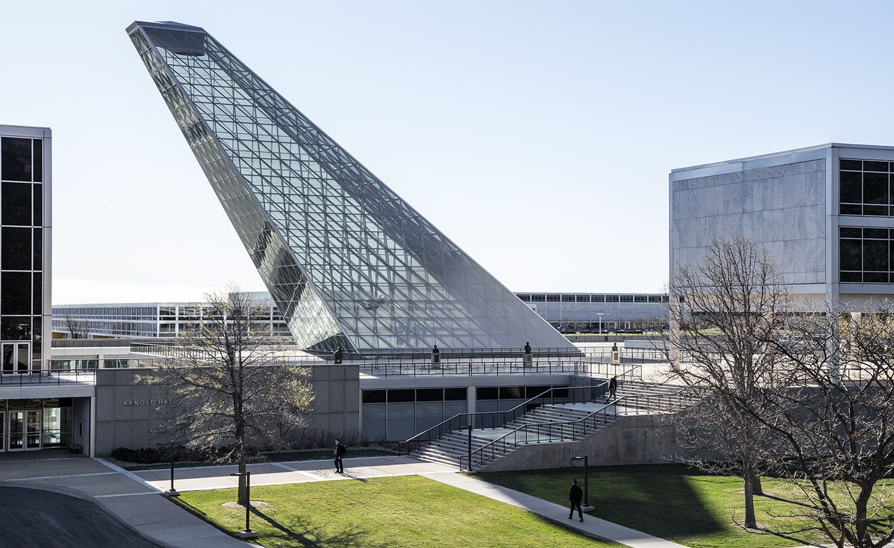 Building featuring a glass and metal structure depicting a plane&#039;s wing