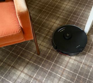 roborock s7 maxv ultra in a living room with checked carpet
