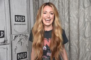 Cat Deeley posing at an event looking happy