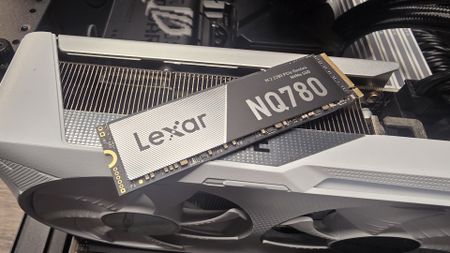 A Lexar NQ780 SSD installed inside a gaming PC and on top of a graphics card.