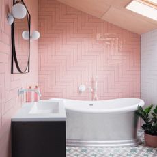 Pink bathroom with white bathtub and sink with black accents 