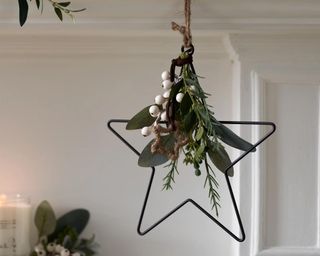 Mini Nordic Star Christmas Decoration hanging with faux greenery