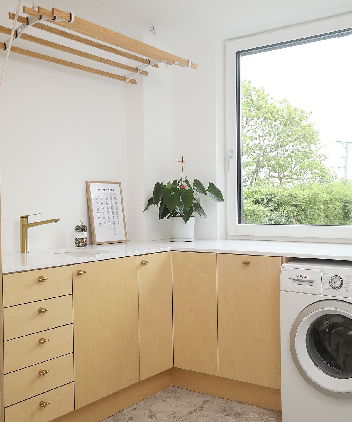 A modern utility room with laundry facilities and storage