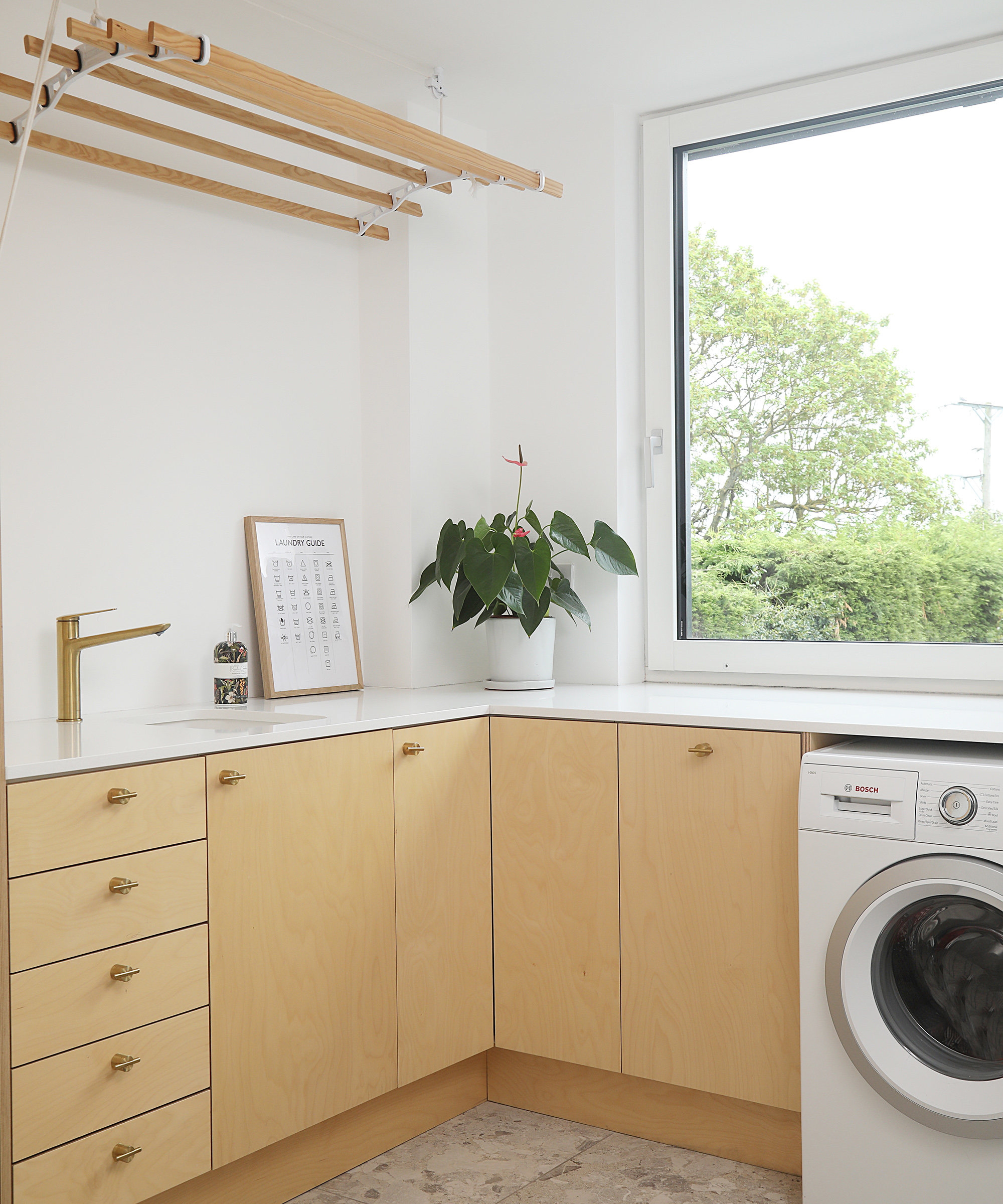 A modern utility room with laundry facilities and storage