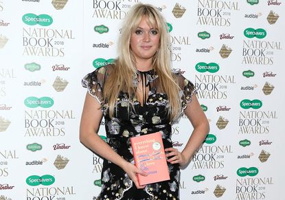 Writer and author Dolly Alderton posing with her book Everything I Know About Love