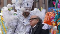 Charlie in parade clown costume hugging Frank in It's Always Sunny in Philadelphia Season 18