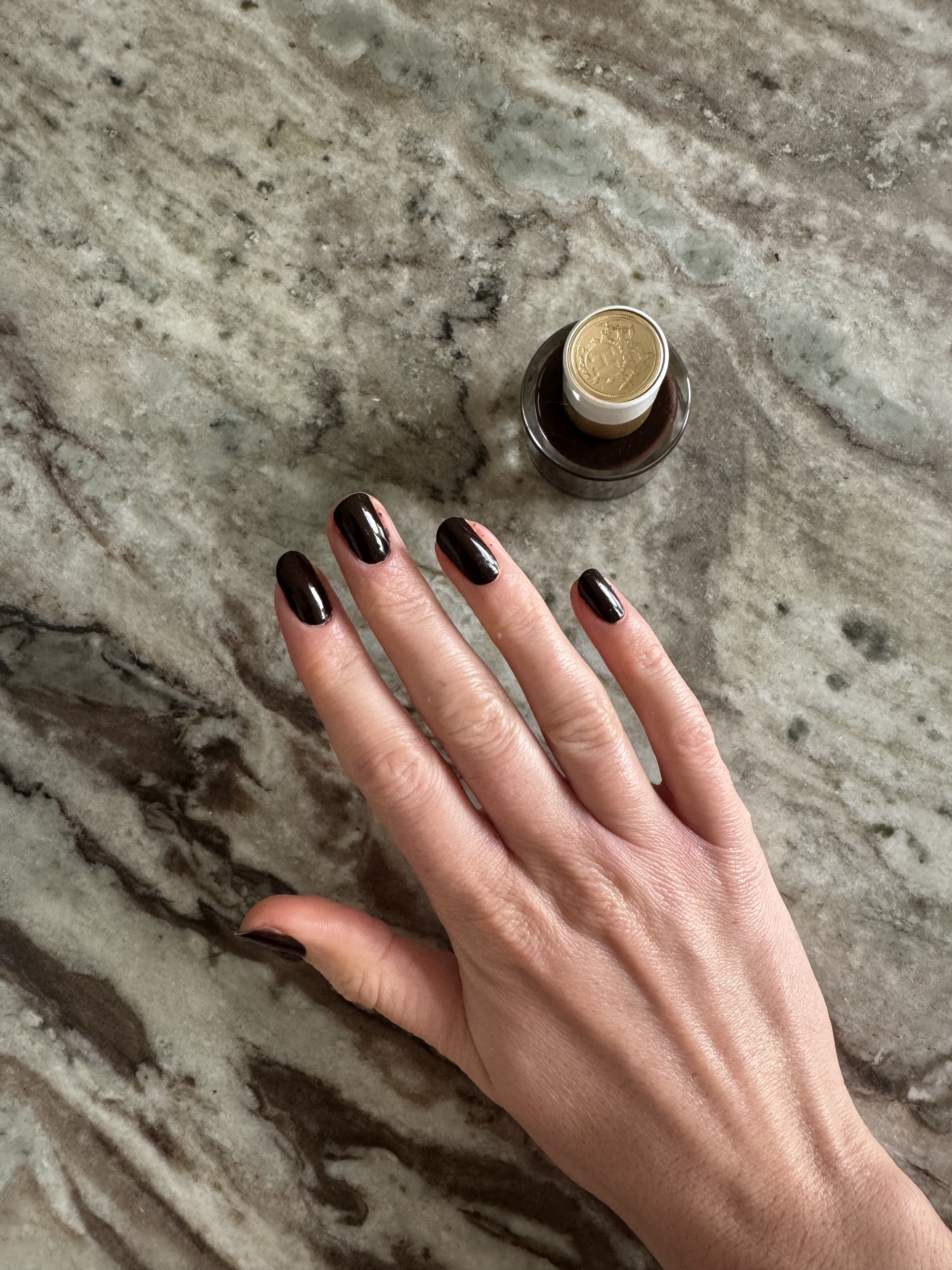 Eleanor wearing Hermes Brun Bistre nail polish on her fingernails