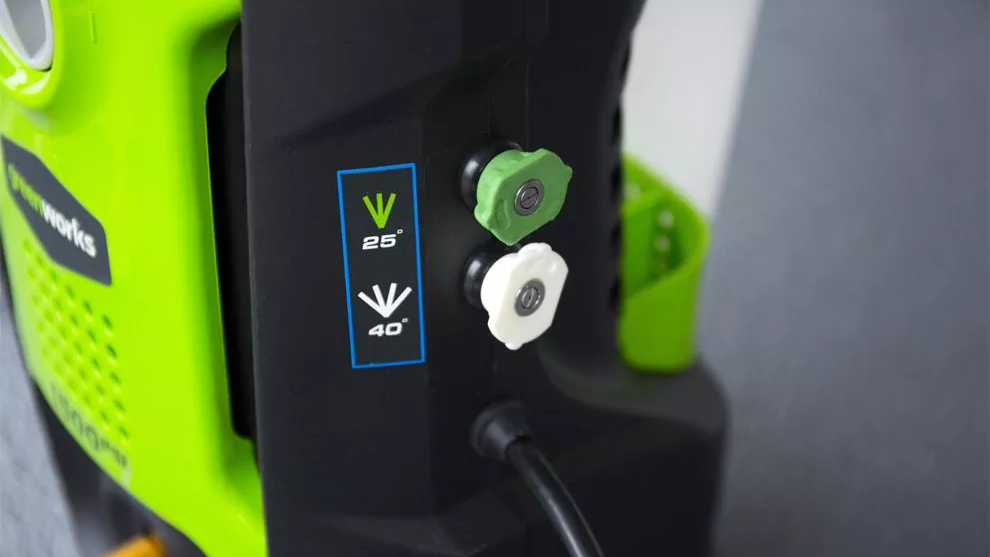 close up of the Greenworks GPW1501 quick-connect nozzles stored on the side of the unit