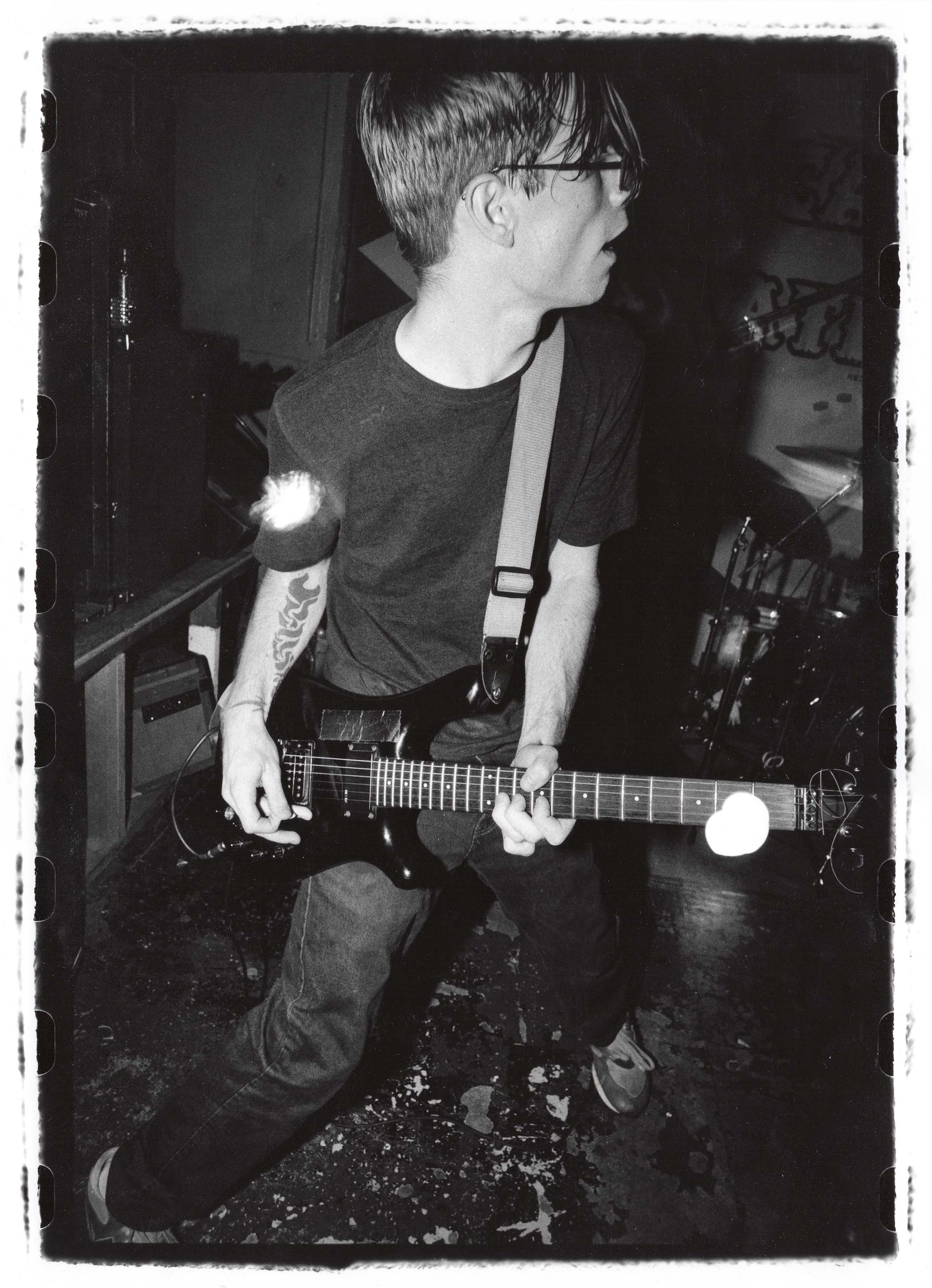 A black and white acrhive shot of Dan Devore performing with Ink &amp;amp; Dagger in the &#039;90s