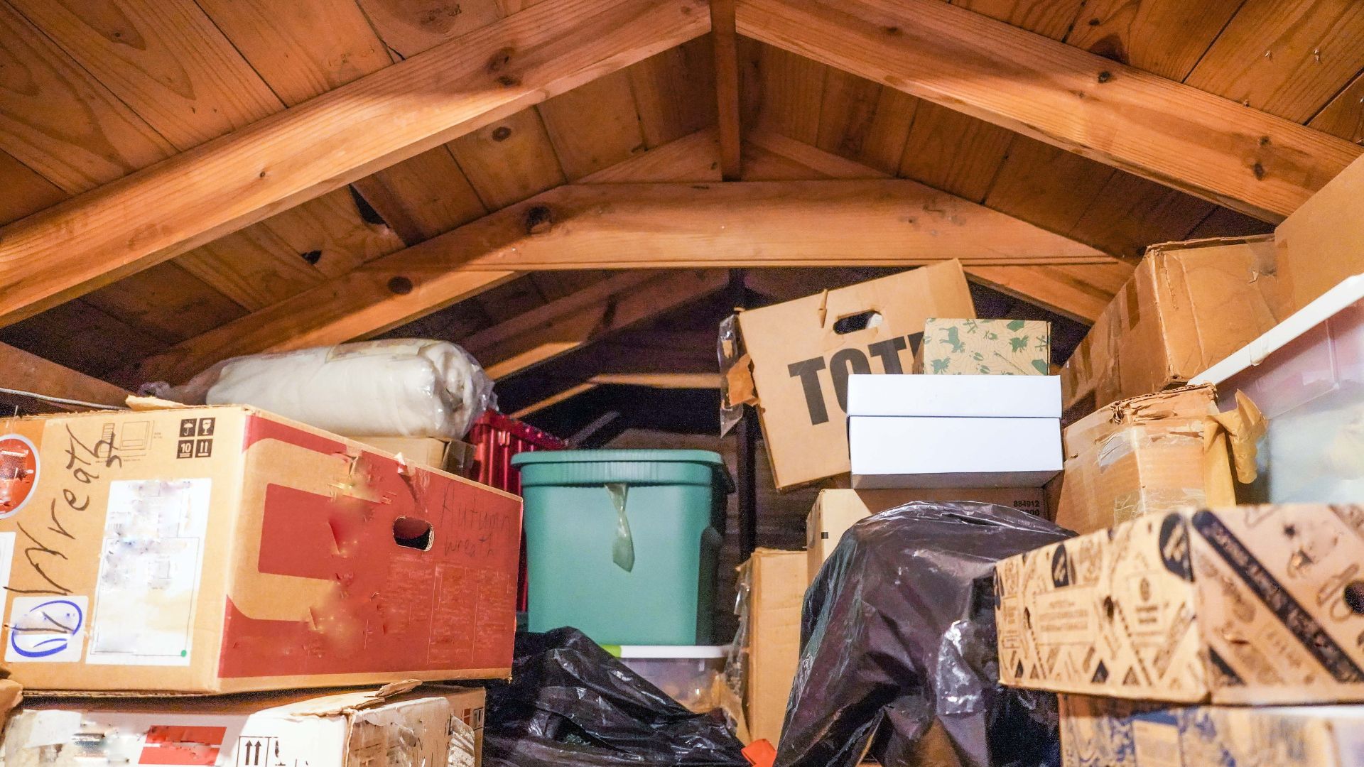 picture of attic space with storage boxes piled high in it